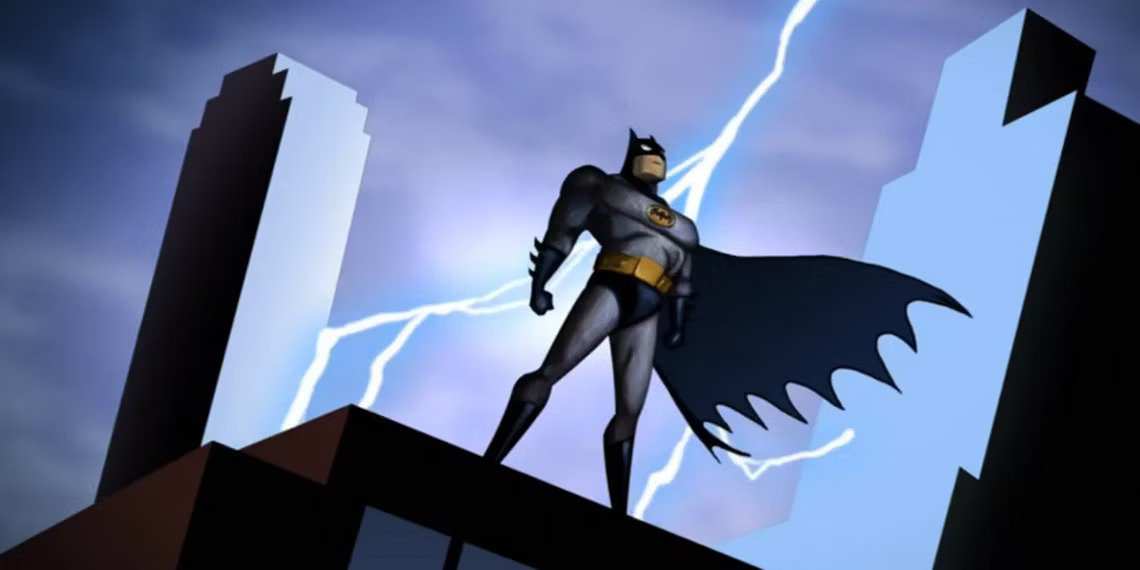 A screenshot from the title sequence of Batman: The Animated Series. An illustrated scene of a man in a bat-inspired costume with a cape stands over the silhouette of a building. Lightning strikes behind him, with other buildings towering in the distance.